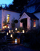 Lit lanterns on steps and porchway of 16th Century Welsh farmhouse
