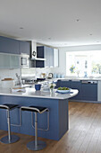 Blue fitted kitchen with Silestone work surfaces in sustainable home Gloucestershire