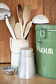 Wooden spoons in utensil holder with storage tins