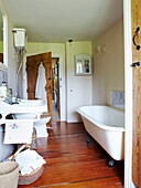 Devon cottage bathroom with wooden floor and wall mounted cistern