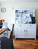 Painted dresser in dining room with wooden floors