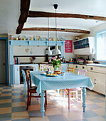 1950s kitchen with beamed ceiling and pastel blue spotted tablecloth