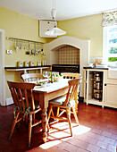 Wooden table and chairs in tiled kitchen