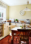 Sunlit kitchen with wooden table and chairs