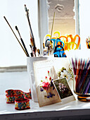 Pens pencils and scissors on shelf in designers studio
