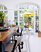 Wooden breakfast bar with stool and view through garden doors
