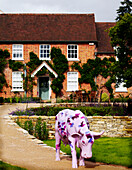 Painted bull on footpath of country house