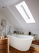 Freestanding bath below skylight in attic conversion