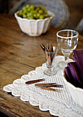Toothpicks and wineglass on wooden tabletop