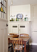 Wooden table and chairs in cream kitchen of country house