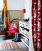 Red cushions on chair in hallway of country home