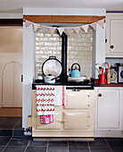 Kettle and saucepan on Aga stove with festive bunting