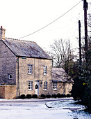 Stone country house in village with snowfall