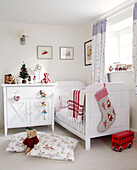 White child's nursery with Christmas stocking and blanket
