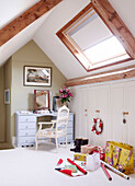 Wrapping paper in attic conversion with dressing table below skylight window