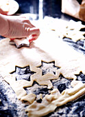 Woman cutting star shapes from pastry