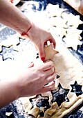 Woman cutting star shapes from pastry