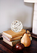 Books and wooden fruit wit paperweight
