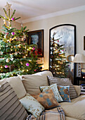 Christmas tree and distressed mirror with cushions on sofa
