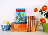 paperback books and map with artificial flowers in Isle of Wight home England UK