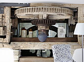 Old mechanism for grinding flour in renovated Cotswolds mill house England UK