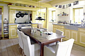 Yellow kitchen with table for six in Abbekerk Dutch province of North Holland in the municipality of Medemblik