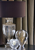 Glass vases and lampbase with brown shade in classic London home, England, UK