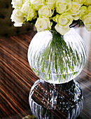 Glass vase of yellow roses in classic London home, England, UK