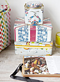 Patterned storage tins with open recipe book in contemporary home, Hastings, East Sussex, UK
