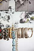 Assortment of bracelets on jewellery stand in contemporary home, Hastings, East Sussex, UK
