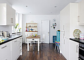 Cream and white kitchen with hardwood flooring