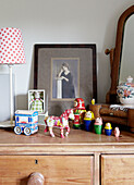 Russian dolls with horse and carriage on wooden chest in child's room in Oxfordshire farmhouse, England, UK