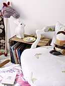 Hobby horse and china rabbit with crate and chair in child's nursery of contemporary Oxfordshire cottage, England, UK
