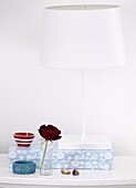 Single stem rose and floral box with lamp in contemporary cottage in Staffordshire home, England, UK