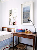 Russian dolls on wooden desk with single bed in girls room of Little London home, Guildford, Surrey, UK