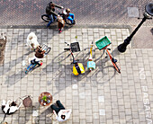 People on city pavement with bikes, Amsterdam, Netherlands