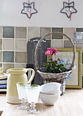 Glasses of lemonade and flower in basket on kitchen counter, Oxfordshire, England, UK
