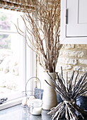 Twig arrangements and egg basket on windowsill of barn conversion in Oxfordshire, England, UK
