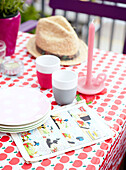 Sunhat with plates and cups on apple motif tablecloth, Mattenbiesstraat, Netherlands