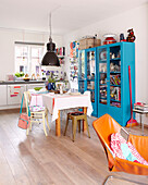 Bright blue glass fronted cabinet in kitchen of Mattenbiesstraat family home, Netherlands