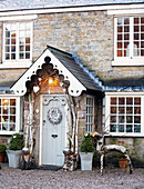 Christmas decorations hang on porch of Derbyshire farmhouse England UK