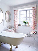 Floral fabric details in bathroom with freestanding bath Derbyshire farmhouse England UK