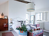 Large lampshade hangs over double bed in Devonshire country home UK