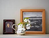 Cut flowers in silver tankard with artwork in Oxfordshire farmhouse England UK