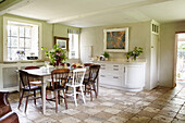 Dining room table and chairs in tiled Oxfordshire farmhouse England UK