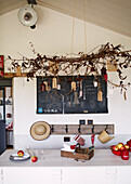 Twig arrangement above table with apples in Brittany schoolhouse conversion France