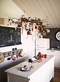 Twig arrangement above table with blackboard in Brittany schoolhouse conversion France