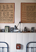 French text and numbers with desk lamp in twin bedroom of schoolhouse conversion Brittany France