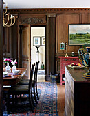 Wood panelled dining room in traditional country house Welsh borders UK