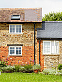Brick and stone exterior of rural Oxfordshire country house England UK